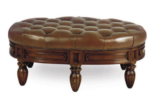 A STAINED MAHOGANY OVAL BUTTON-TUFTED LEATHER OTTOMAN,