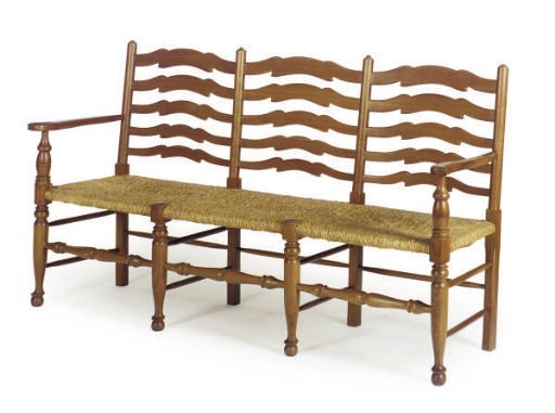 AN OAK SETTEE WITH RUSH SEAT,