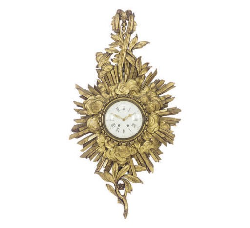 A CONTINENTAL CARVED GILTWOOD STARBURST-FORM CARTEL CLOCK,