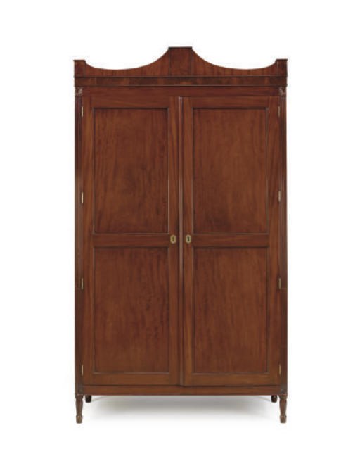 AN AMERICAN CLASSICAL CARVED MAHOGANY CLOTHES PRESS,