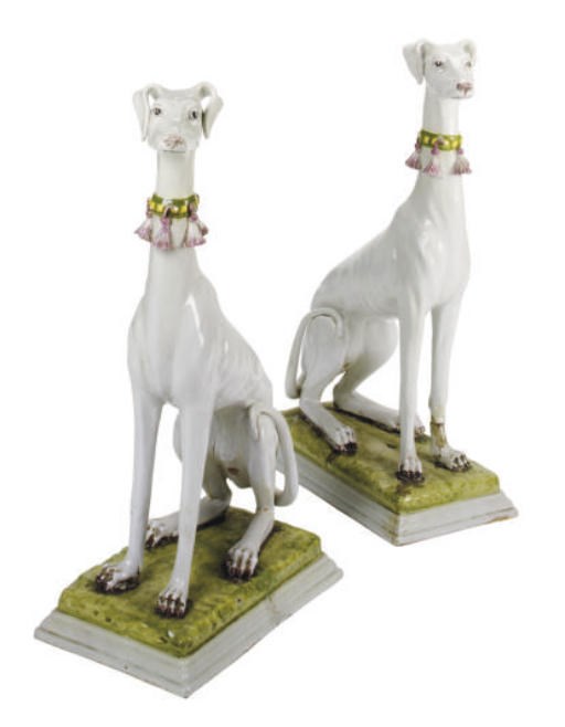 A PAIR OF ITALIAN TIN-GLAZED EARTHENWARE FIGURES OF GREYHOUNDS,