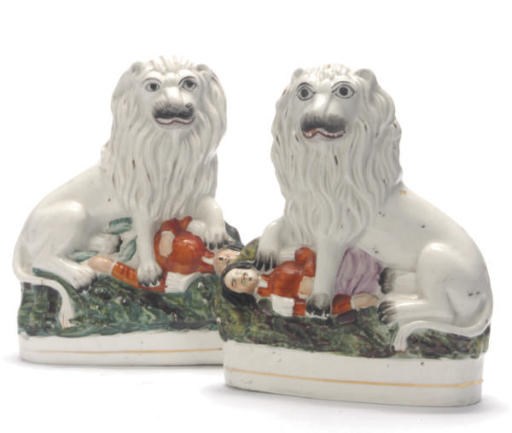 A PAIR OF STAFFORDSHIRE MODELS OF LIONS SLAYING HIGHLANDERS,