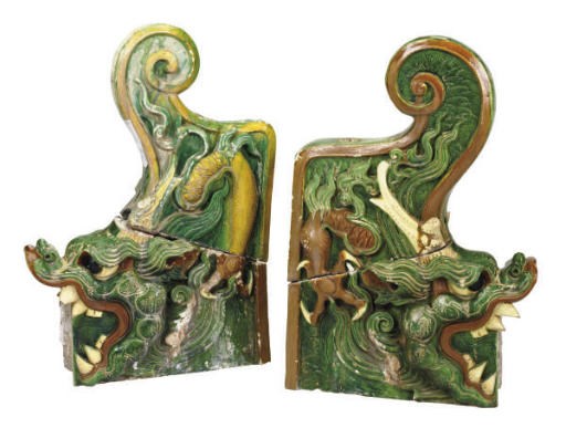 A PAIR OF CHINESE GREEN, CREAM AND AMBER-GLAZED TILEWORKS DRAGON-FORM ROOF ORNAMENTS,