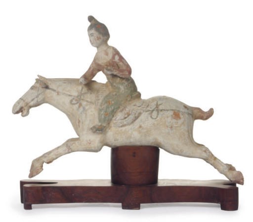 A CHINESE TANG-STYLE PAINTED POTTERY FIGURE OF A FEMALE POLO PLAYER,