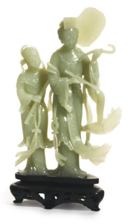 A CHINESE PALE GREEN JADITE FIGURAL GROUP OF A FEMALE IMMORTAL AND ATTENDANT,