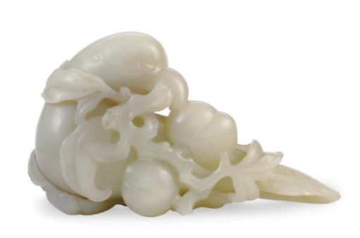 A SMALL WHITE JADE FIGURE OF A PARROT WITH PEACHES,