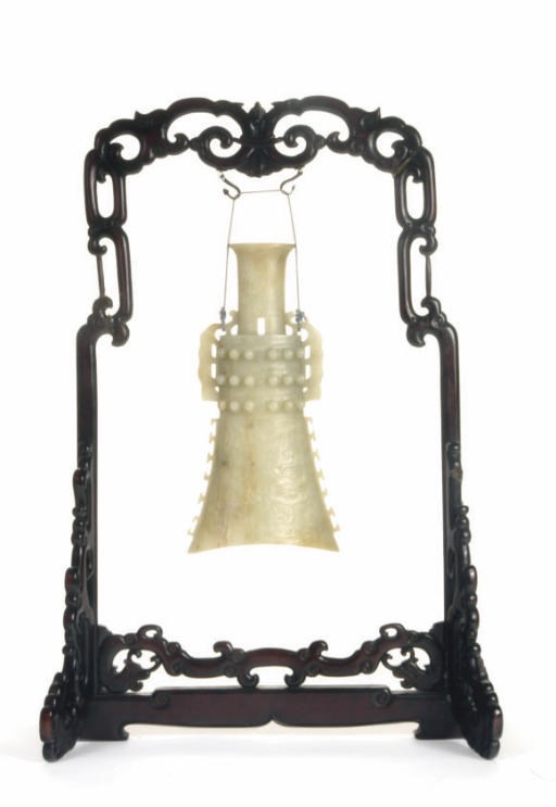 A CHINESE PALE GREENISH-WHITE JADE ARCHAISTIC BELL AND WOOD STAND,