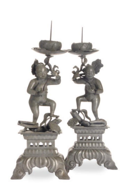 A PAIR OF CHINESE PEWTER PRICKET CANDLE STICKS MODELED AS YOUNG BOYS,