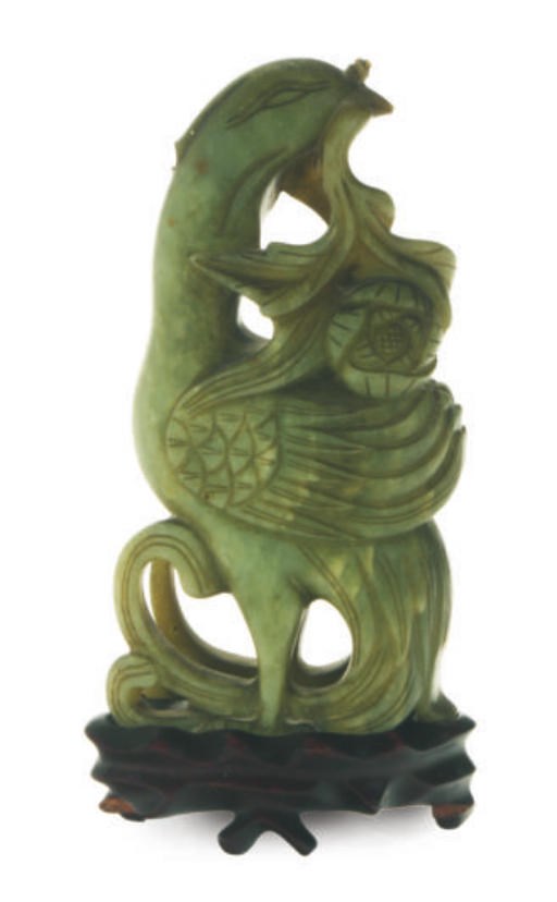 A CHINESE GREEN HARDSTONE FIGURE OF A PHOENIX WITH A FLOWER,