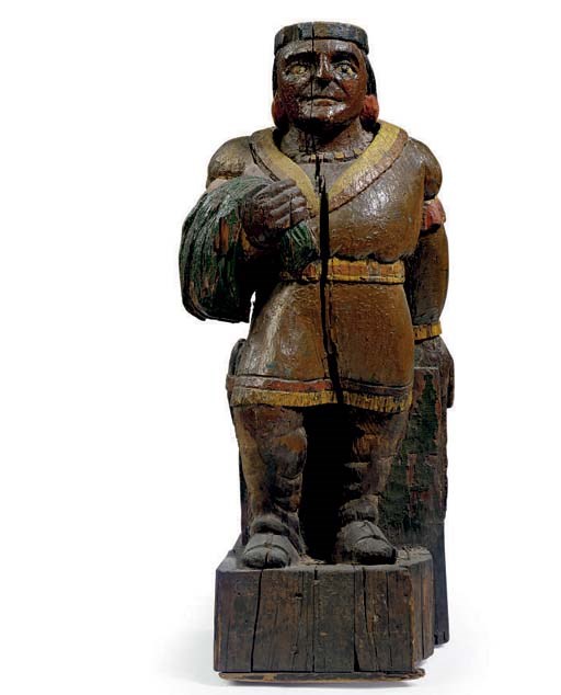 A DIMINUTIVE CARVED AND PAINT-DECORATED INDIAN FIGURE