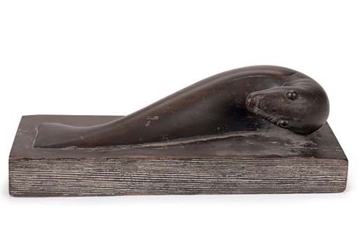 A NATIVE AMERICAN PAINTED AND CARVED WOOD SEAL