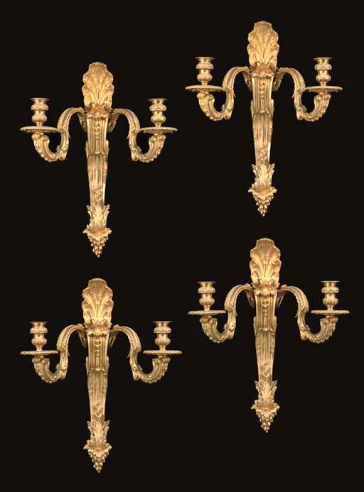 A SET OF FOUR REGENCE STYLE ORMOLU TWIN-LIGHT WALL-APPLIQUES