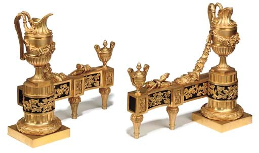A PAIR OF LOUIS XVI STYLE ORMOLU AND BLACK-ENAMELLED CHENETS