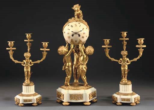 A LOUIS XVI STYLE ORMOLU AND WHITE MARBLE THREE-PIECE GARNITURE