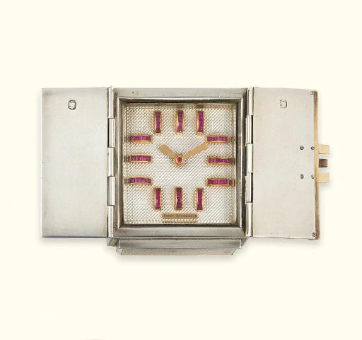 A SILVER AND RUBY NOVELTY TRAVEL CLOCK