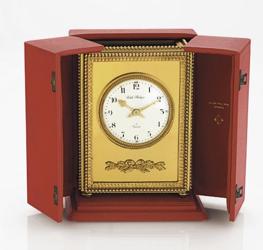 PATEK PHILIPPE.  A GILT-BRASS SOLAR-POWERED MANTEL CLOCK