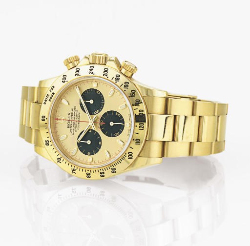 ROLEX. AN 18K GOLD AUTOMATIC CHRONOGRAPH WRISTWATCH WITH BRACELET