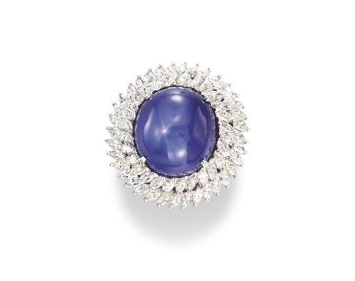 A CABOCHON STAR SAPPHIRE AND DIAMOND RING