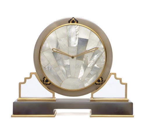 A ROCK CRYSTAL, AGATE, MOTHER-OF-PEARL AND BLACK ENAMEL TABLE CLOCK, BY CARTIER