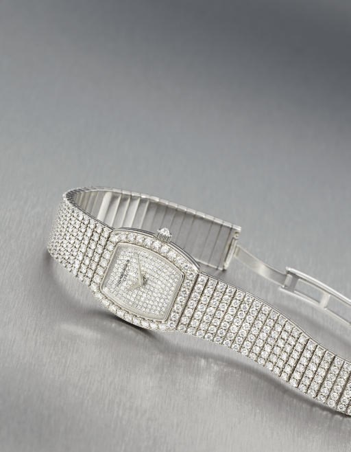 VACHERON CONSTANTIN. A LADY'S 18K WHITE GOLD AND DIAMOND-SET TONNEAU-SHAPED WRISTWATCH WITH BRACELET