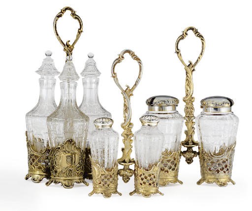 AN AUSTRIAN THREE-PIECE SILVER-GILT AND GLASS CRUET SET