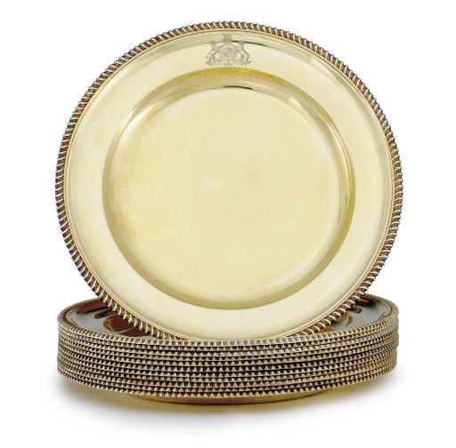 A SET OF TWELVE VICTORIAN SILVER-GILT DINNER PLATES