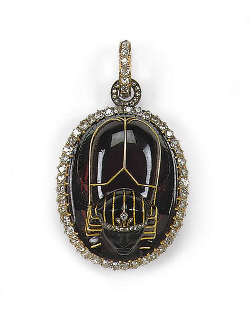 AN ANTIQUE NEO-EGYPTIAN GARNET AND DIAMOND PENDANT