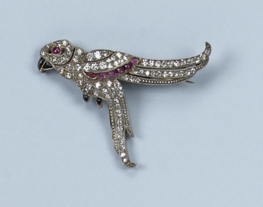 AN ART DECO RUBY, ONYX AND DIAMOND PARROT BROOCH