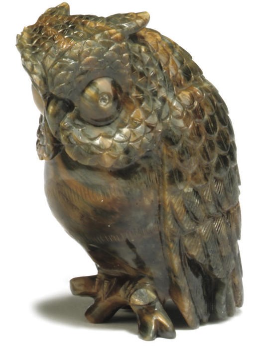 A CARVED TIGER'S EYE AGATE MODEL OF AN OWL