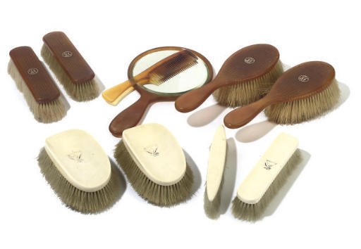A GROUP OF EIGHT IVORY AND BLONDE TORTOISESHELL BRUSHES AND A HAND MIRROR