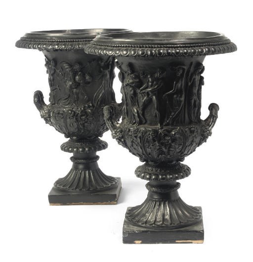 A PAIR OF BLACK PAINTED PLASTER URNS