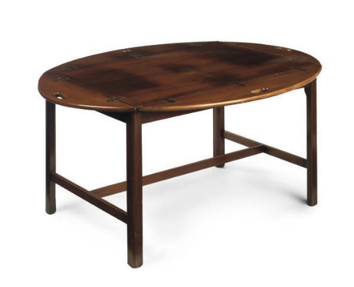 AN OVAL MAHOGANY BUTLER'S TRAY ON A LOW STAND