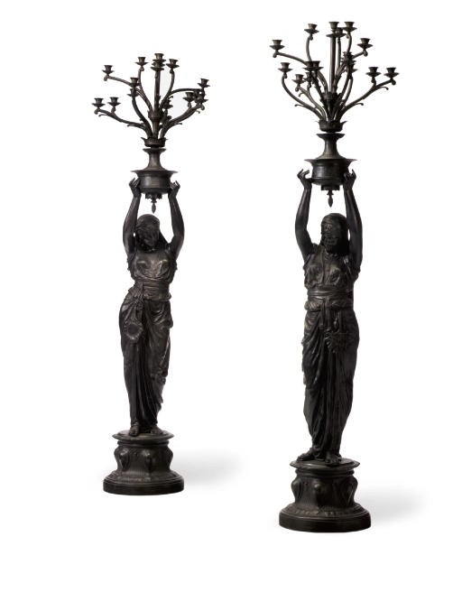 A PAIR OF FRENCH ORIENTALIST PATINATED SPELTER FIGURAL TORCHERES
