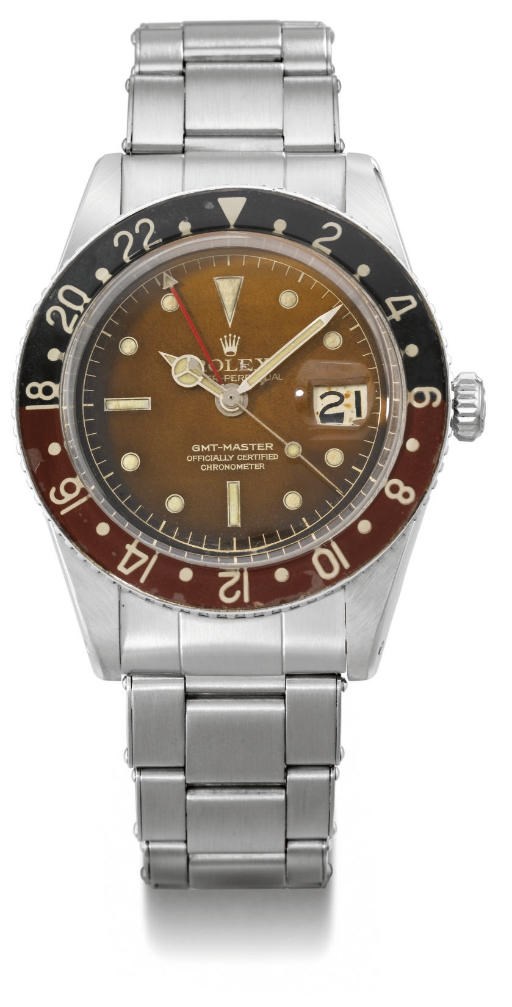 Rolex. A rare and early stainless steel self-winding water-resistant dual time wristwatch with sweep centre seconds, date, bracelet, bakelite bezel and brown-coloured dial