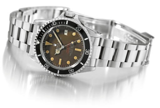 Rolex. A fine and rare stainless steel self-winding wristwatch with sweep centre seconds, date, bracelet and brown dial