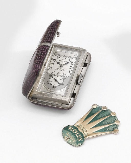 Rolex. A rare stainless steel and leather purse watch with two-tone silvered dial and original Rolex tag
