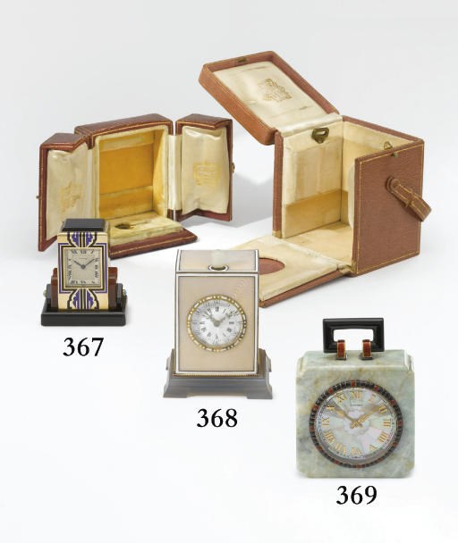 Cartier. A fine and rare 18K gold, onyx, carnelian and enamel 8-day desk clock with box and key