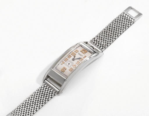 Movado. An unusual, large and early 18K white gold rectangular curved hinged wristwatch with 14K white gold bracelet