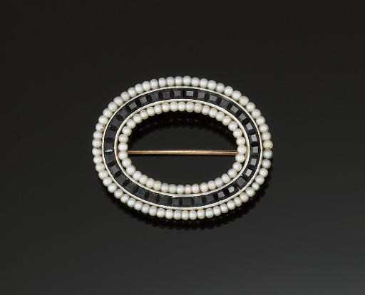An early 20th century seed pearl and onyx brooch