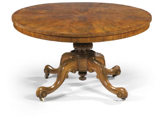 A VICTORIAN MAHOGANY AND WALNUT CIRCULAR CENTRE TABLE