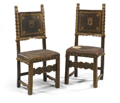 A PAIR OF ITALIAN WALNUT, PARCEL-GILT AND LEATHER UPHOLSTERED SIDE CHAIRS