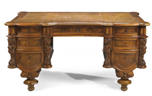 A GERMAN WALNUT KNEEHOLE DESK