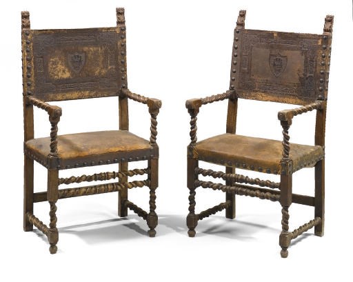 A PAIR OF ITALIAN LEATHER UPHOLSTERED WALNUT AND PARCEL-GILT ARMCHAIRS