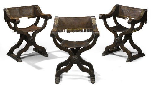 A SET OF THREE NORTH ITALIAN WALNUT AND PARCEL-GILT X-FRAME ARMCHAIRS