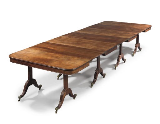 A GEORGE III MAHOGANY EXTENDING DINING-TABLE