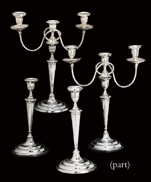 A SET OF FOUR GEORGE III SILVER CANDLESTICKS AND A PAIR OF THREE-LIGHT BRANCHES