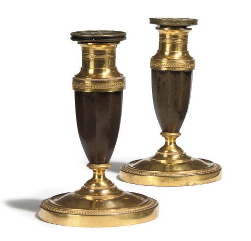 A PAIR OF NORTH EUROPEAN ORMOLU AND BRONZE CANDLESTICKS