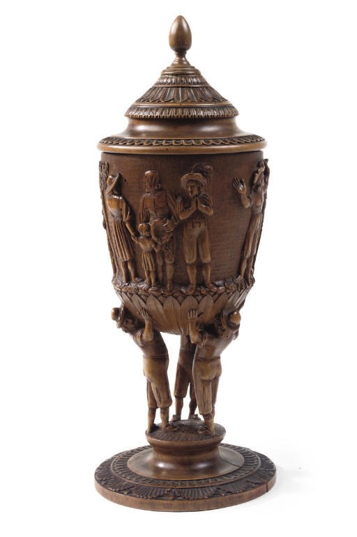 A GERMAN CARVED WALNUT CUP AND COVER