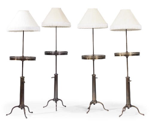 A SET OF FOUR FRENCH LACQUERED BRASS AND MAHOGANY ADJUSTABLE STANDARD LAMP TABLES