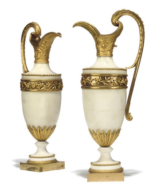 A PAIR OF DIRECTOIRE ORMOLU-MOUNTED WHITE MARBLE EWERS